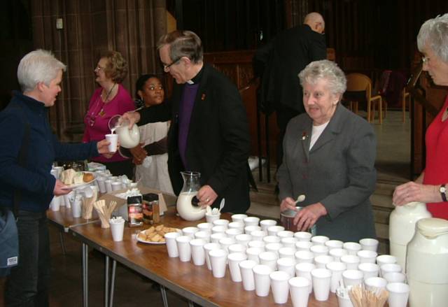 Bishop Nigel and other members serve refreshments to clergy